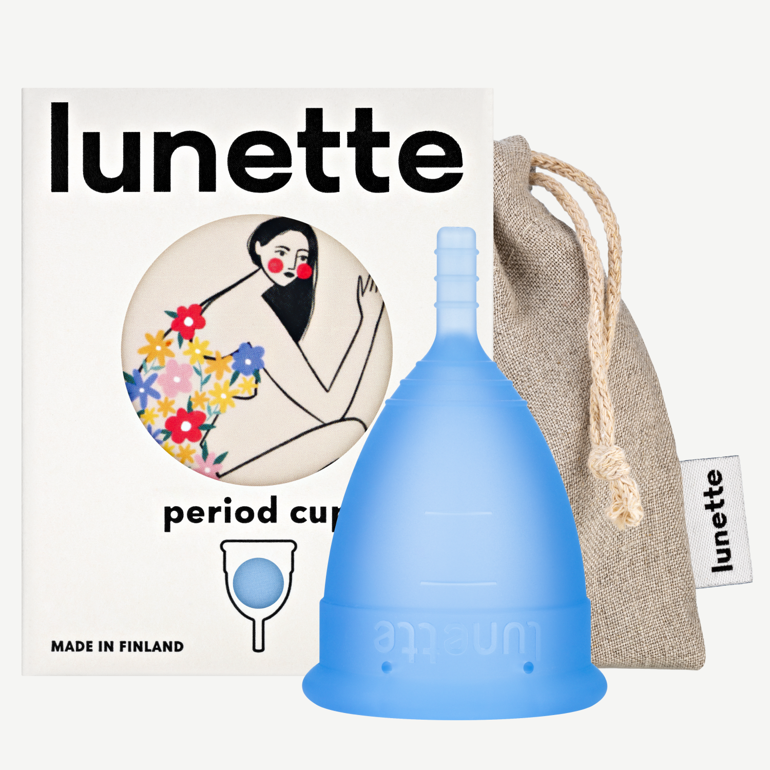A blue Lunette period cup displayed alongside its packaging box with a floral design and a linen storage pouch. The box includes the text 'period cup', 'made in Finland', and the brand name 'Lunette'.